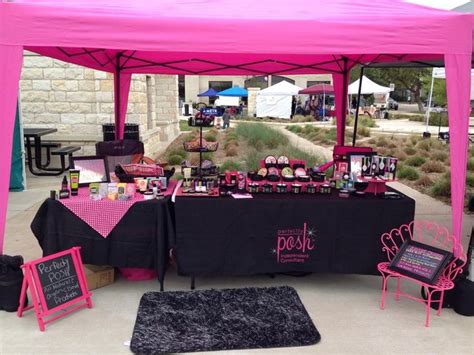 A Pink And Black Tent Set Up For An Outdoor Event With Chalkboard Signs