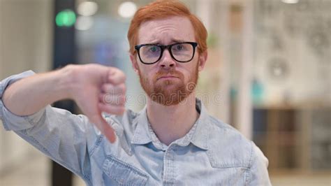 Disappointed Young Redhead Man Doing Thumbs Down Stock Photo Image Of