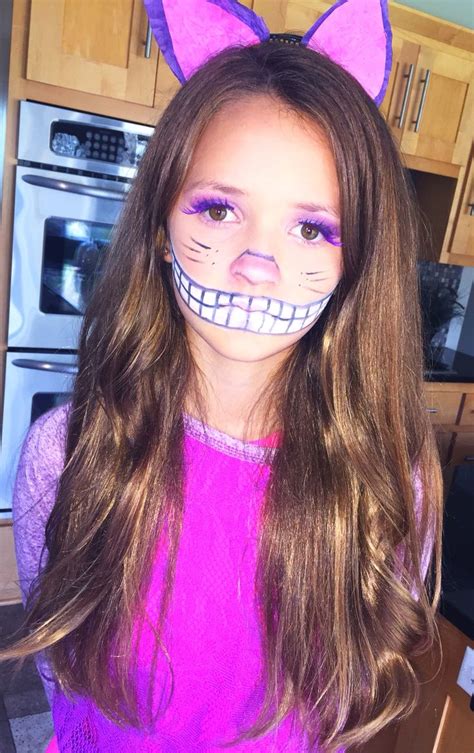 For the colorful cat costume, get yourself a pair of pink tights, a pink and purple feather boa (for the tape), feather earrings, feather lashes, and a pink hoodie dress. Cheshire Cat Halloween makeup costume DIY | Diy cheshire cat costume, Girls cheshire cat costume ...