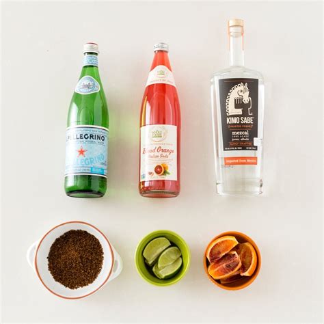 the ingredients needed to make an alcoholic drink are displayed on a white surface including
