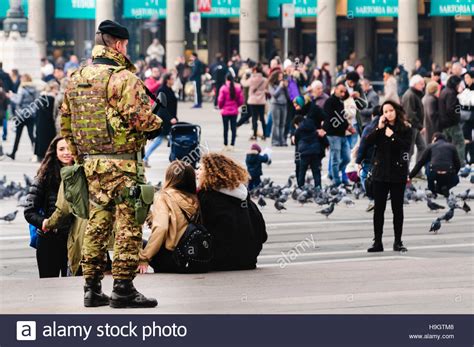 A Soldier From The Italian Army Armed With Sa80 Assault Rifle Watches The Crowd For Suspicious