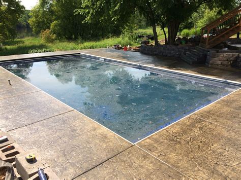 Decorative Concrete Pool Deck With Cantilevered Edge Over Retaining