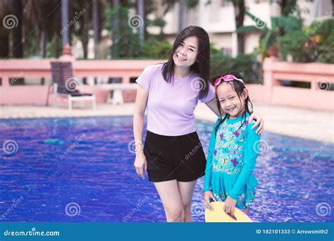 asian mother and daughter hugging and stand up side the swimming pool stock image image of