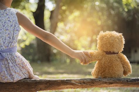 Child Holding Hands With Teddy Little Acorns Fostering