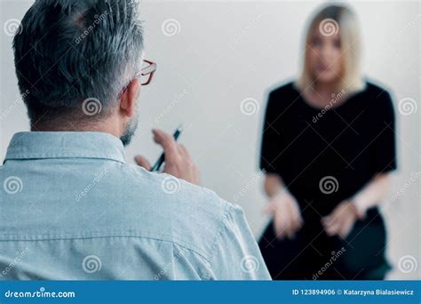 Close Up Of A Therapist Holding A Pen And Talking Stock Photo Image