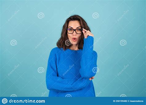 A Woman In A Blue Knitted Sweater And Natural Make Up Curly Short Hair