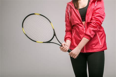 Premium Photo Young Woman Holding A Tennis Racket