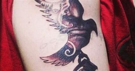 A Hollywood Undead tattoo. The Dove and Grenade tat on the arm. I think