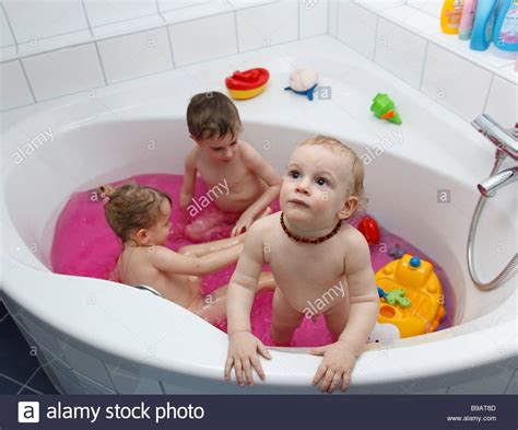 Children Playing In Bath Tub With Pink Water Stock Photo 22980845 Alamy