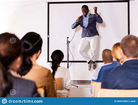 Young Emotional Male Coach Giving Motivational Speech Stock Photo