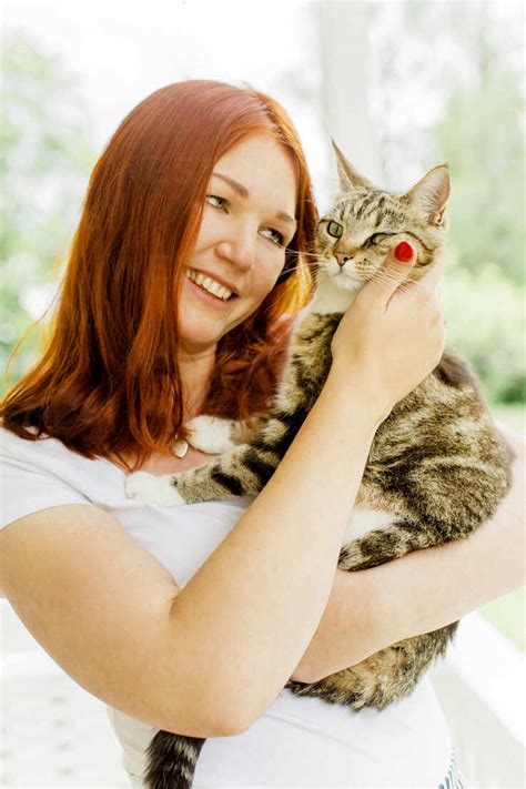 Young Woman Holding Cat Stock Photo