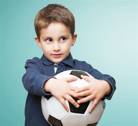 Premium Photo Young Caucasian Man Holding A Soccer Ball Showing Fist