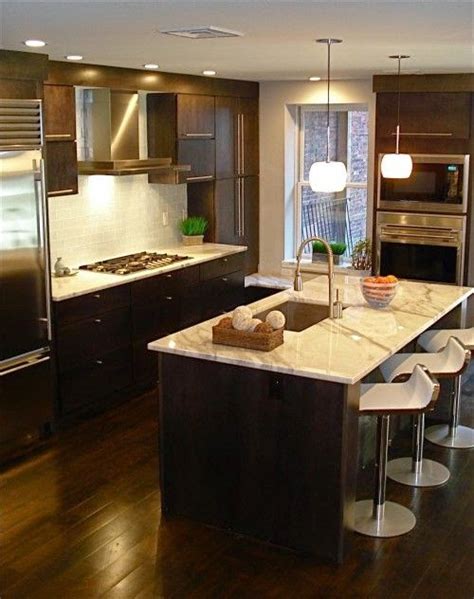 To really drive the dark wood floor look home in your kitchen, partner it up with other wood finishes throughout the space. Designing Home: Thoughts on choosing dark kitchen cabinets