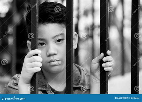 Asian boy behind iron bars stock photo. Image of asian - 65709802