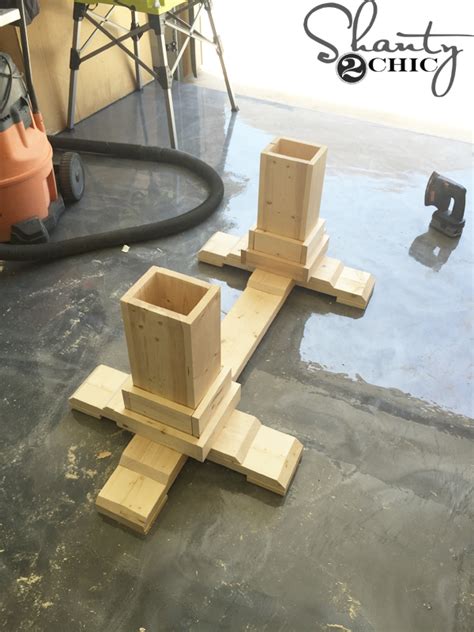 Thick wood is used to construct the frame, perched on a rectangular base. DIY Pedestal Coffee Table - Shanty 2 Chic