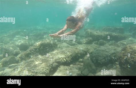 Young Woman In A Bikini Swimming Underwater In The Sea Underwater Shot