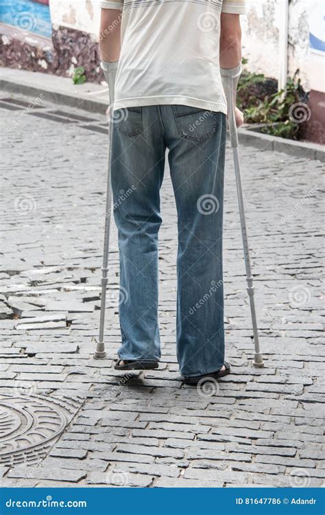 The Disabled Person Walks In Park On Crutches Stock Photo Image Of