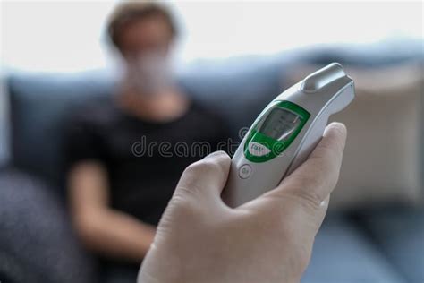 The Father Is Checking Temperature His Son`s With Infrared Thermometer