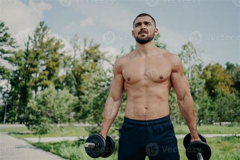 Fitness Athlete Muscular Man Holds Barbells In Hands Has Naked Perfect Body Strong Arms And