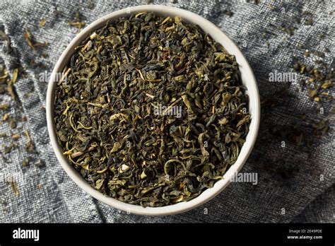 Dry Green Organic Tea Leaves In A Bowl Stock Photo Alamy