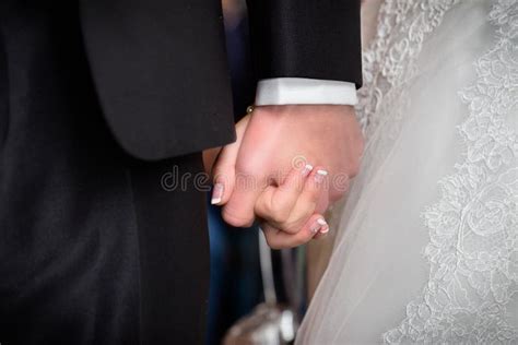 Bride And Groom Holding Hands During Wedding Ceremony Stock Image