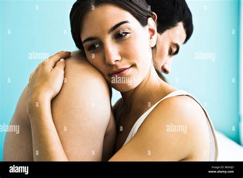 Couple embracing, woman resting head on man's shoulder Stock Photo - Alamy