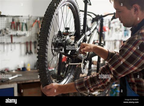 Man Mechanic Working In Bicycle Repair Shop Technician Repairing