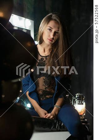 Nice brunette posing while sittingの写真素材 PIXTA