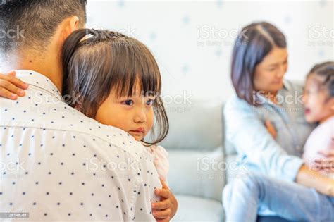 Sad And Crying Asian Girls Being Comforted By Their Parents Stock Photo