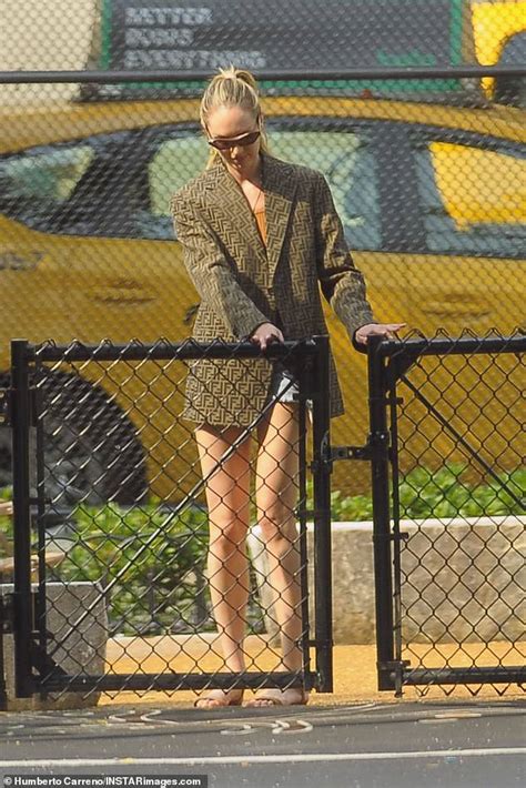 Candice Swanepoel Wears Denim Cutoffs To Grab A Smoothie And Help Her