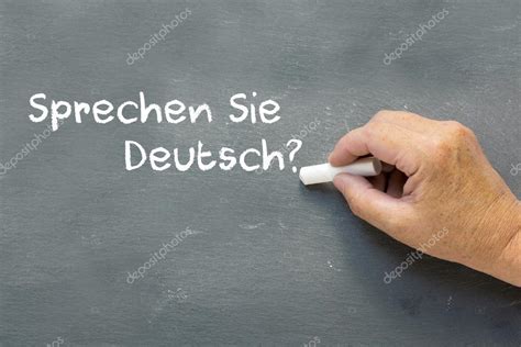 Hand On A Chalkboard With The German Words Sprechen Sie Deutsch — Stock