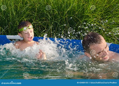 Father And Son Having Fun In The Swimming Pool Stock Image Image Of