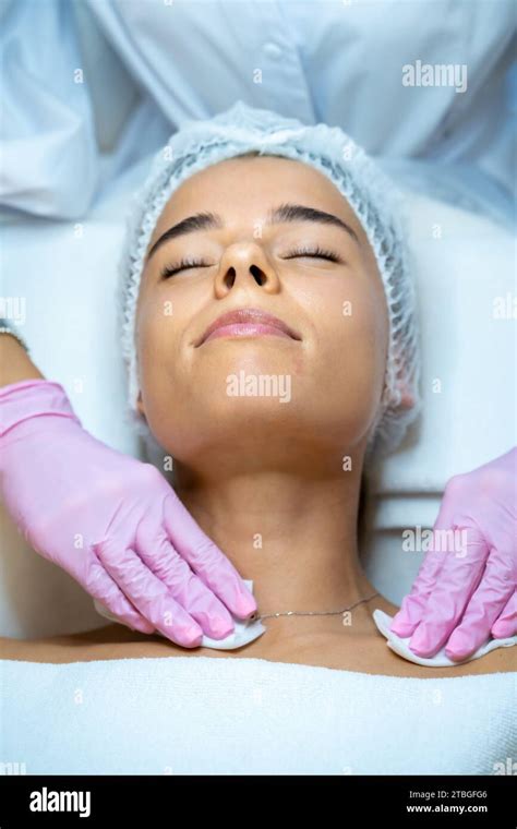 Unrecognizable Female Beautician Doctor Cleaning Customer Skin Make