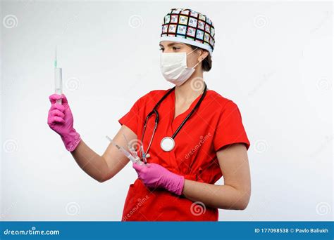 Female Doctor In Red Form Holding Syringes In Hands Medicine
