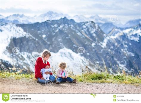 Three Children In Beautiful Snow Covered Mountains Stock Photo Image