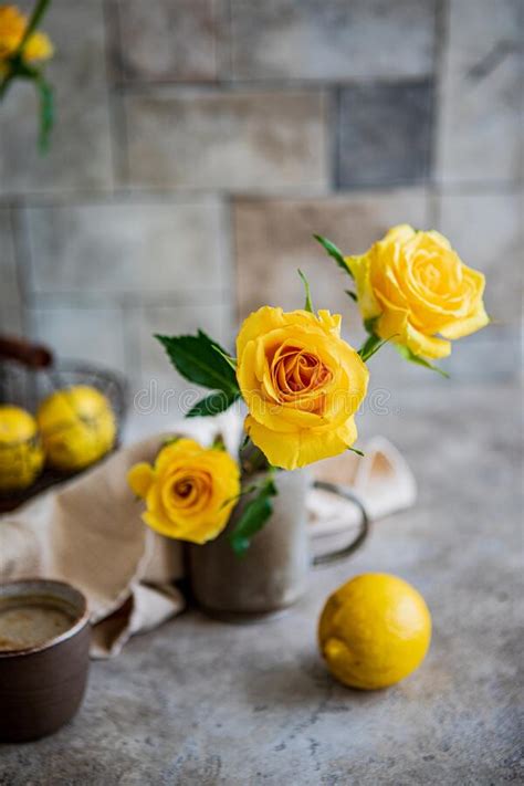 Kitchen Still Life With Yellow Roses In A Metal Vase Lemons And A Cup