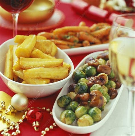Herby roast potatoes, honeyed parsnips and orange carrots. Christmas dinner vegetables - Stock Image - H110/2458 ...