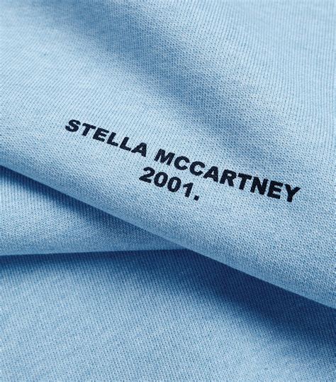 Download Designer Fabric With Stella Mccartney Logo Wallpaper