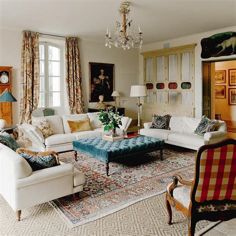 French Country Living Room With Cream Walls And Patterned Curtains Via @provencepoiriers 