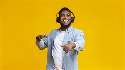 Black Man Enjoying Listening His Favorite Music In Headphones Stock