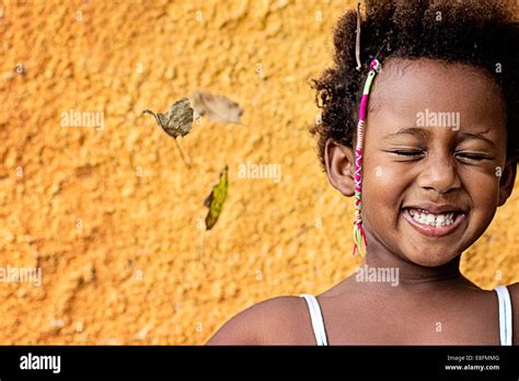 Portrait Of A Smiling Girl Standing Against Yellow Wall Stock Photo Alamy