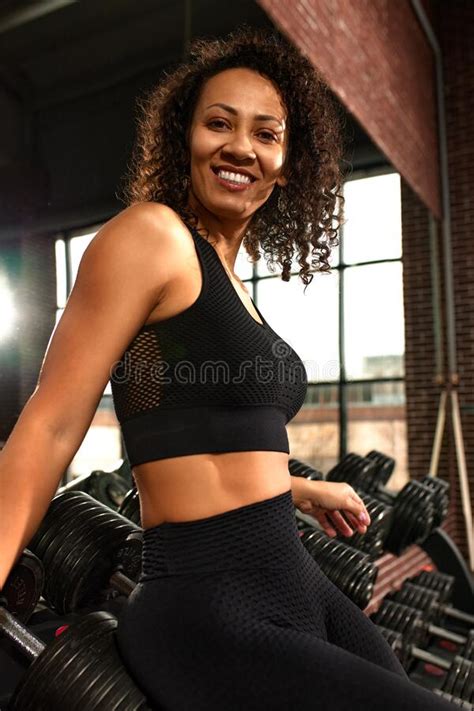A Slender Athletic African American Woman In Sportswear Does Exercises