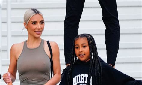 north west poses as kanye west in video with kim kardashian