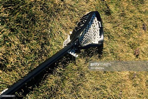 Lacrosse Racket Lying On Grassy Field Closeup High Res Stock Photo