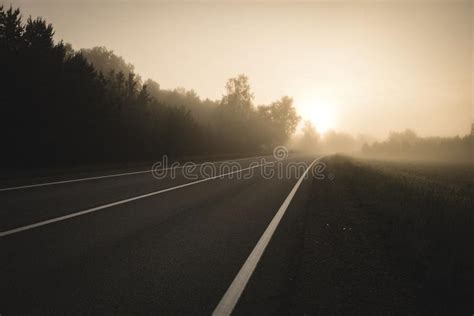 Empty Asphalt Road With White Lines Painted In Misty Morning Vintage