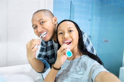 Premium Photo Father And Child Taking Selfie While Brushing Teeth