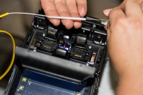 Fiber Optic Cable Splicing By Engineer With Optical Fiber Fusion