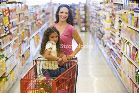 Mother And Daughter Grocery Shopping In Supermarket Royalty Free Stock Image Storyblocks
