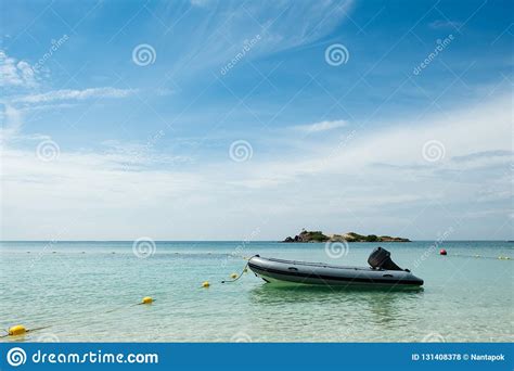 Inflatable Rubber Motor Boat Floating On Blue Sea With Blue Sky
