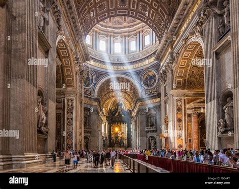 Tourists And Visitors Inside St Peters Basilica With Light Shafts